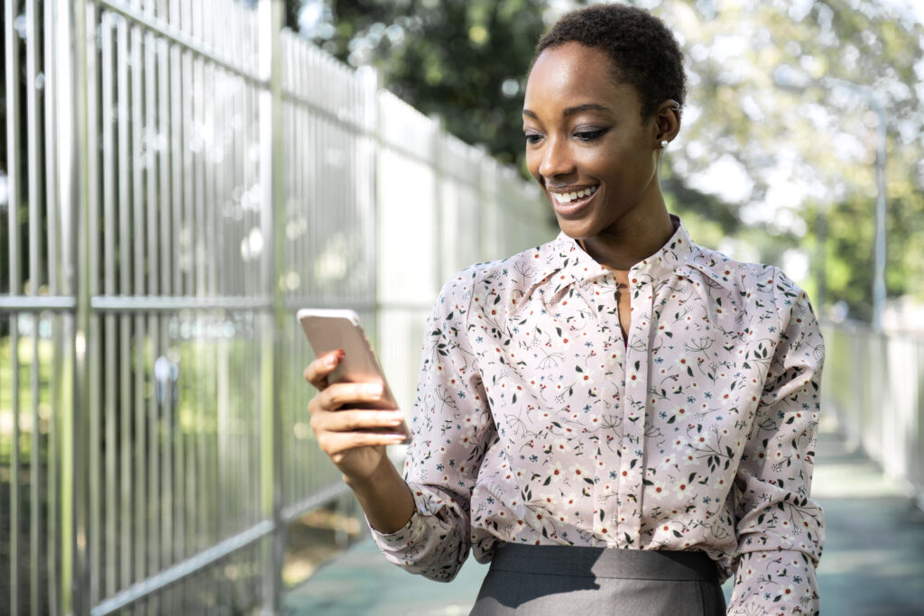 woman using E-nsure app happy